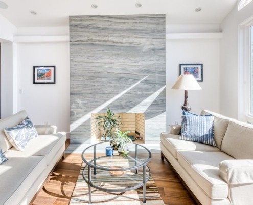 A cozy living room with a fireplace and comfortable couches, perfect for relaxation and warmth.