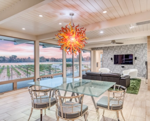 A spacious dining room featuring a sizable glass table surrounded by chairs.