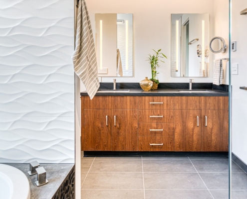 A spacious bathroom featuring a sizable tub and a generously sized mirror.