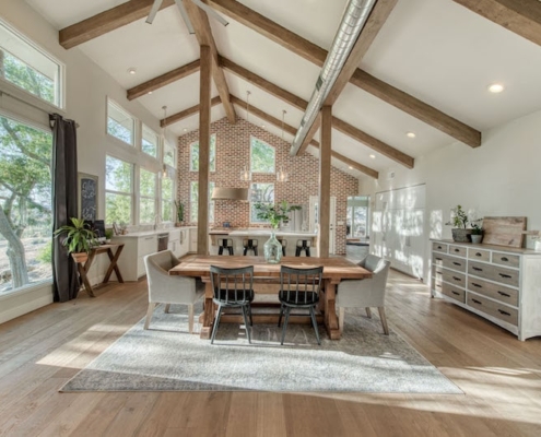 A spacious kitchen and dining area with high ceilings, providing an open and inviting atmosphere.