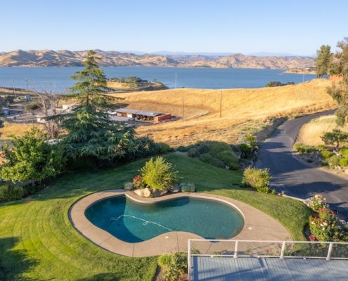 Aerial view of a pool and lake, showcasing their serene beauty and tranquil surroundings.