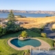 Aerial view of a pool and lake, showcasing their serene beauty and tranquil surroundings.