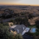Aerial view of a house and pool surrounded by a vast field. Aerial view of a house and pool surrounded by a vast field.