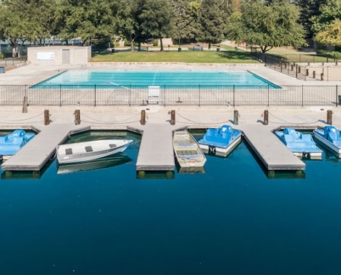 A serene pool with several boats docked, creating a picturesque scene of tranquility and leisure.