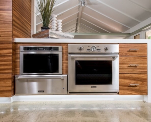 Modern kitchen with stainless steel appliances and wooden cabinets.