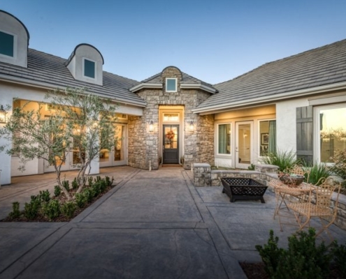 Photo of outdoor entry way to luxurious entrance to beautiful home and a furnished lounge patio