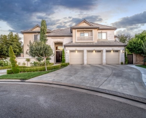Photo of front view of luxurious home and scenic background