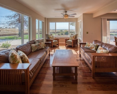Photo of interior view on living room with all wood furniture on wooden floors